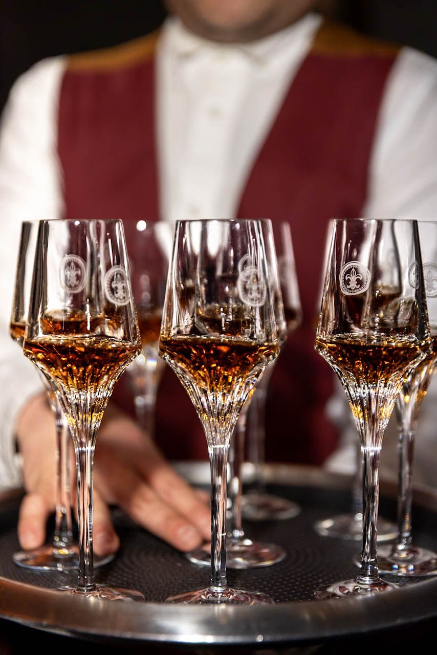 A silver tray of poured Louis XIII glasses